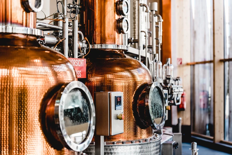 alembic still for making alcohol inside distillery